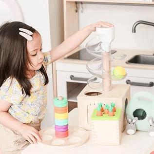 Child with playthings from The Babbler Play Kit